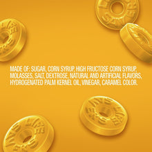 Yellow embossed hard candy discs with ingredient details on the packaging