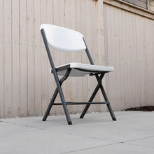 White folding chair with contoured back and seat, steel frame on patio floor