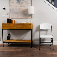 White folding chair with contoured seat and back, steel frame and side supports