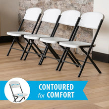 Set of white folding chairs with black steel frames, contoured seats and backs