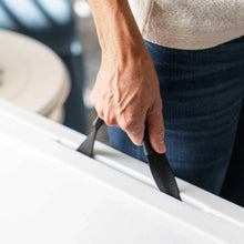 Fold-in-half table support latch with hand securing the leg mechanism