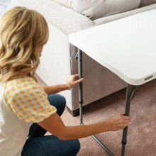 Adjustable folding table leg height adjustment under the white tabletop