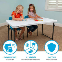 White folding table with black legs and protective foot caps for indoor use