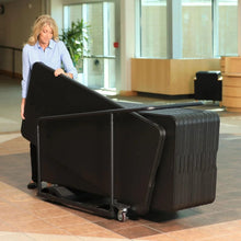 Stacked folding tables with black cases and caster wheels