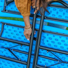 Close-up of blue picnic table frame and legs with attached bench supports.
