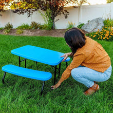 Blue kids picnic table with attached bench seats for outdoor play on grass.