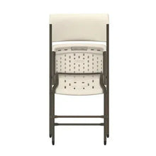 Almond folding chair close-up: padded back and perforated panel, foldable metal frame