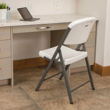 White folding chair with contoured seat and back, grey metal frame