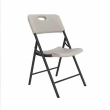 Almond folding chair with contoured seat, oval hole on back, black frame