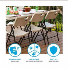 Set of almond folding patio chairs with contoured seats and black frames