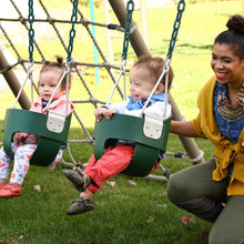 Green toddler bucket swing with chains in outdoor play area