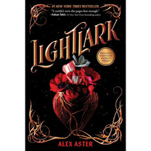 Paperback book with ornate gold title and red flowers on dark cover