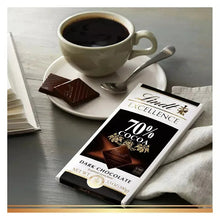 Lindt Excellence 70% cocoa dark chocolate bar on plate, next to cup