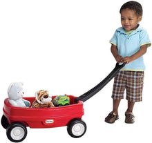 Little Tikes Lil' Wagon red push cart with toys inside, child standing beside