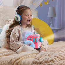 Child holding the blue and pink story dream machine while wearing headphones