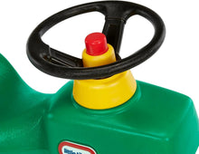 Yellow steering wheel hub and black steering wheel on green ride-on tractor