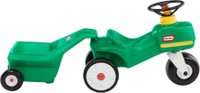 Green ride-on tractor with attached cart, white wheel rims, black steering wheel