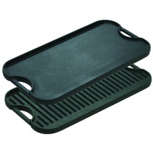 Reversible cast iron grill/griddle with black handles and ridged grate