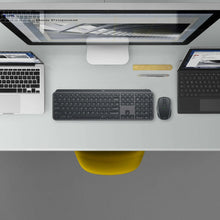 Logitech MX keyboard and mouse combo viewed from above, dark gray keys and mouse