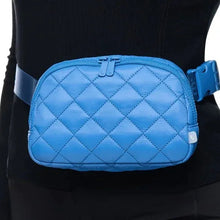 Blue quilted belt bag with front emblem detail, zipper top, and adjustable strap
