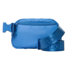 Quilted belt bag in blue with zip top and adjustable crossbody strap