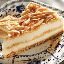 Shortbread cookie bar slice with creamy layer and sliced topping on plate