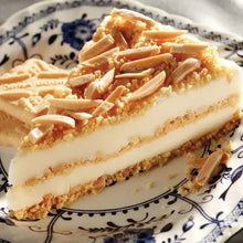 Shortbread cookie bar topped with almond slices on a decorative plate
