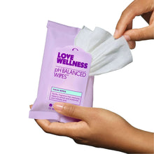 Love Wellness pH Balanced wipes pouch held with stacked wipes