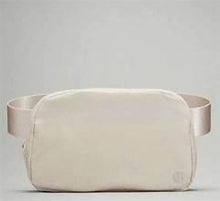 Lululemon Athletica belt bag 1L in white, front view with top zip and wide strap