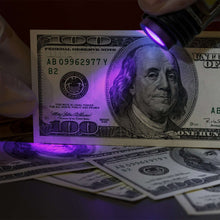 UV flashlight with purple glow emitting from clear head