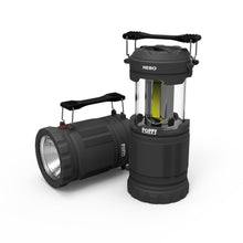 Gray battery-powered lantern/spotlight with front flood head and side handle.