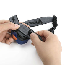 Blue-and-black headlamp with hands adjusting the black strap