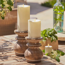 Set of 3 cream LED candles in round wooden bases, flickering flame tops.