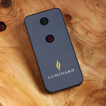 Black Luminara remote with power and flame buttons for outdoor candles.