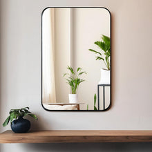 Bathroom wall mirror with black frame and rounded corners, single reflective panel.