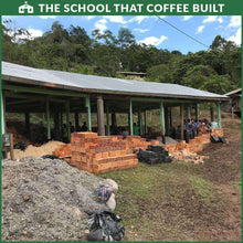 Luna Roasters coffee school-building photo, construction area with stacked bricks and people