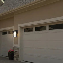 Black outdoor LED wall lantern mounted on an exterior wall