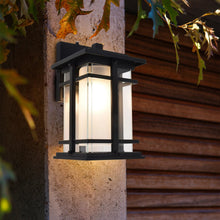 Black outdoor LED wall lantern with illuminated frosted glass panels