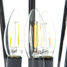 Close-up of glass lantern with warm LED bulbs inside a black outdoor post light