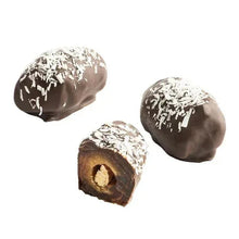 Chocolate-covered dates coated in white shavings, two whole and one sliced center