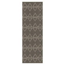 Dark jute runner rug with repeating geometric triangle motif, vertical rectangular.