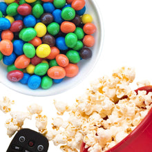 Colorful peanut chocolate candies in a white bowl, scattered for serving