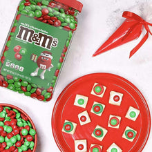 Red and green milk chocolate candies with M&Ms jar and gift ribbon