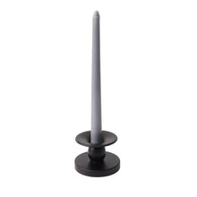 Black flippable candle holder with upright candle stem and round base