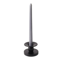 Black flippable candle holder with a pillar candle standing upright