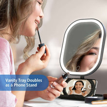 LED makeup mirror with open vanity tray, phone stand, and hinged viewing display
