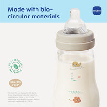 Clear glass baby bottle with cream collar and mint nipple, animal splash print