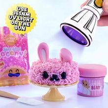 Pink bunny resin mini figure on pedestal with small jars and purple tool