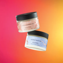 Two MIX:BAR body scrub jars with black lids, vanilla bourbon and coconut