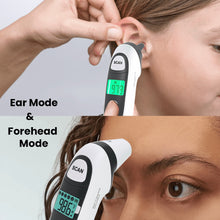 Infrared thermometer held on forehead area with green LCD temperature readout
